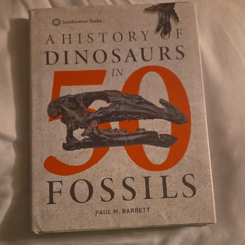 Smithsonian Books 'A History of Dinosaurs in 50 Fossils' - Cream and Orange